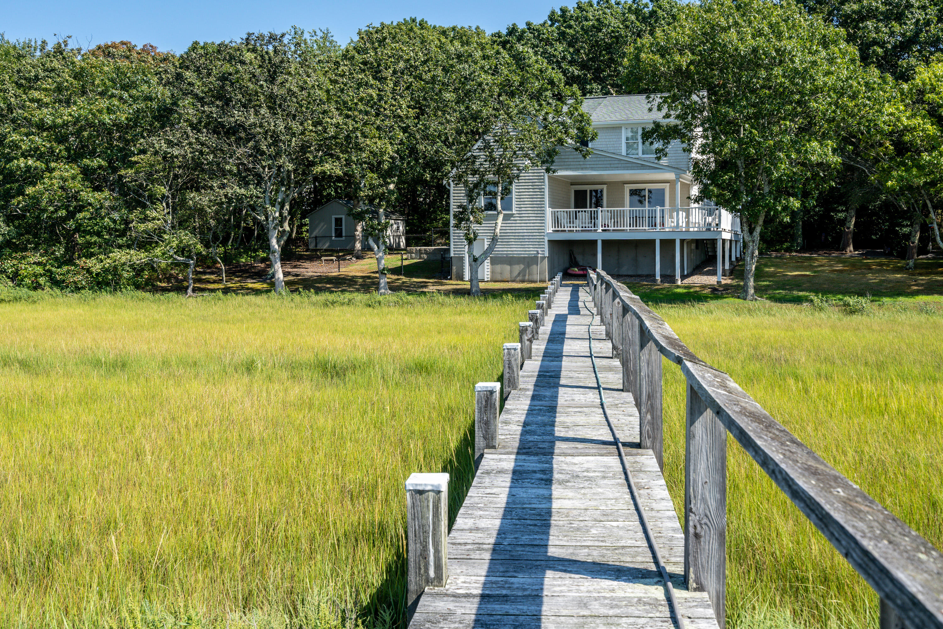 17 Monomoscoy Road West Mashpee, MA 02649 - Photo 23 of 36 a house with swimming pool in front of it