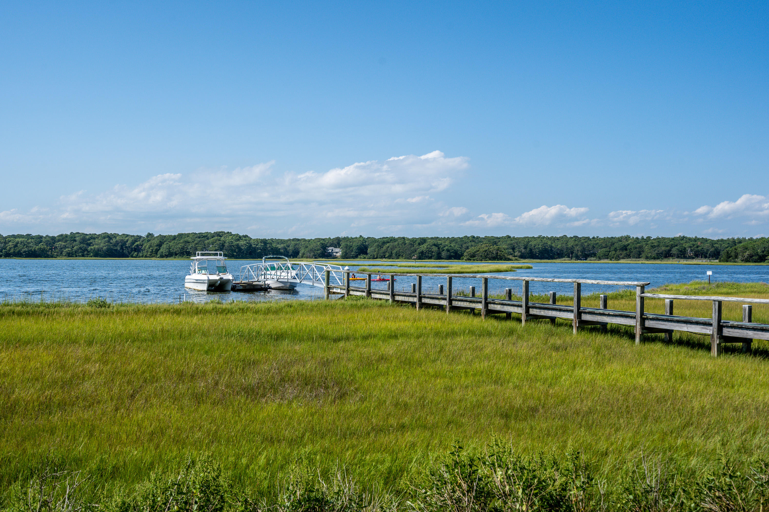 17 Monomoscoy Road West Mashpee, MA 02649 - Photo 24 of 36 a view of a lake with houses in the back