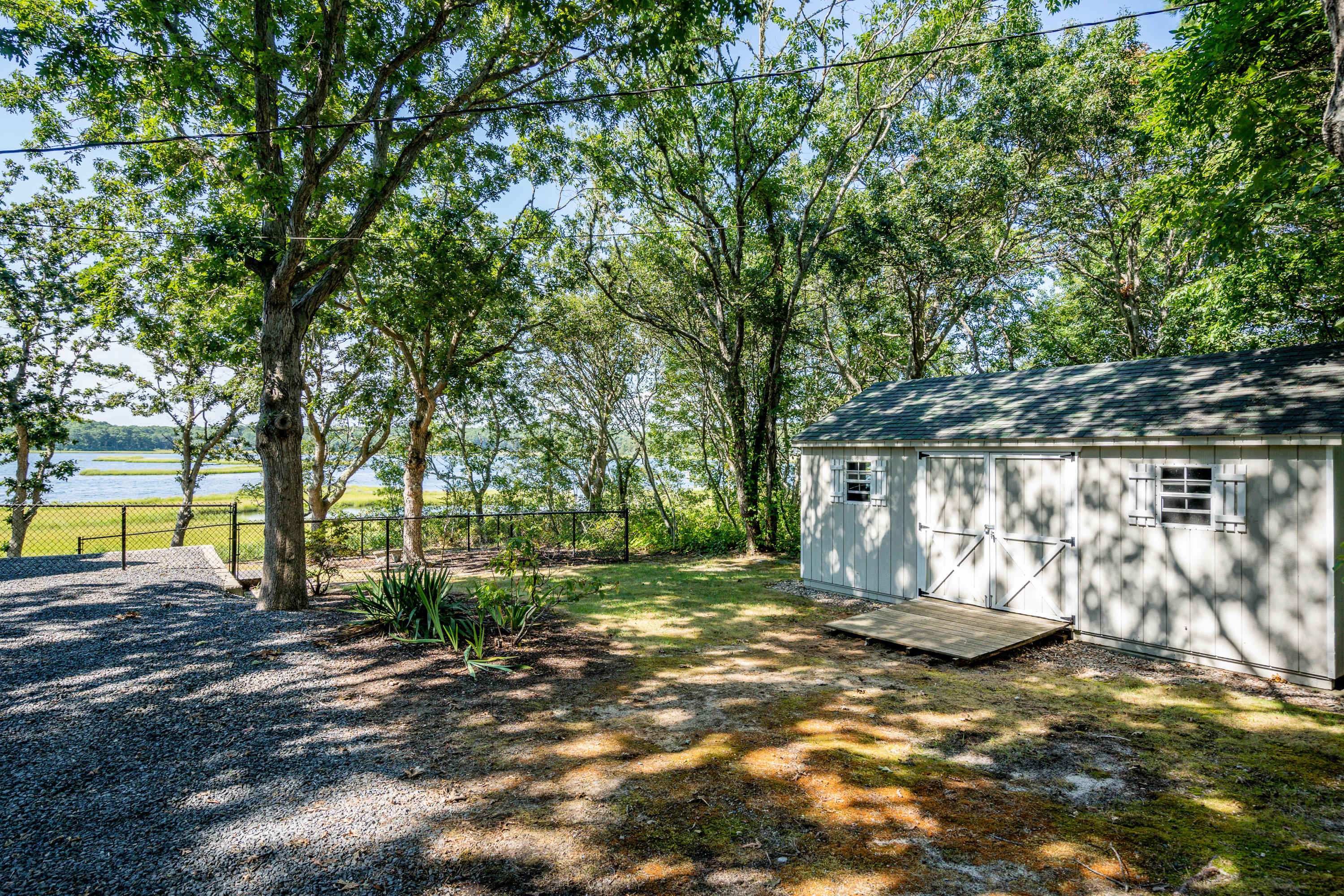 17 Monomoscoy Road West Mashpee, MA 02649 - Photo 31 of 36 a view of a yard with wooden fence