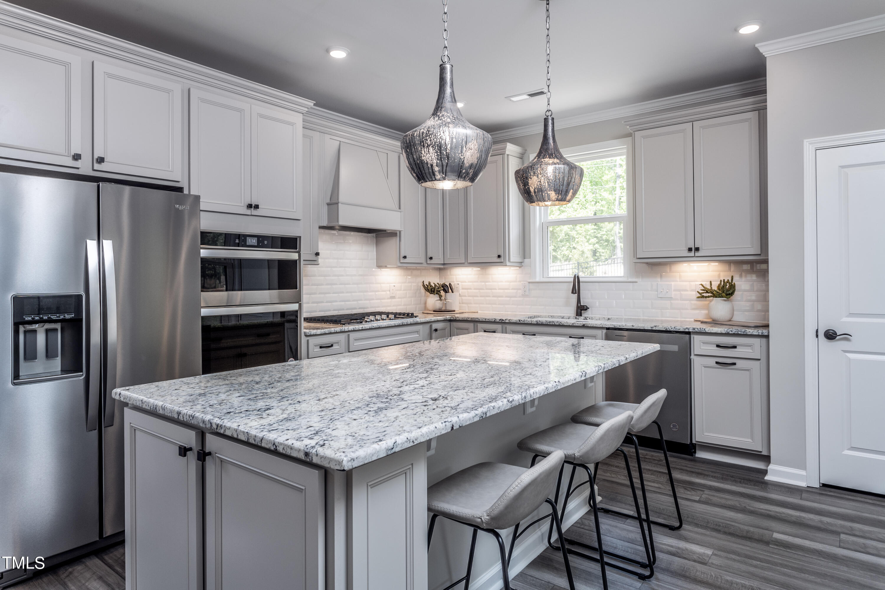89 Shadowbrook Trail Clayton, NC 27520 - Photo 2 of 17 a kitchen with stainless steel appliances granite countertop a sink a stove a refrigerator and island