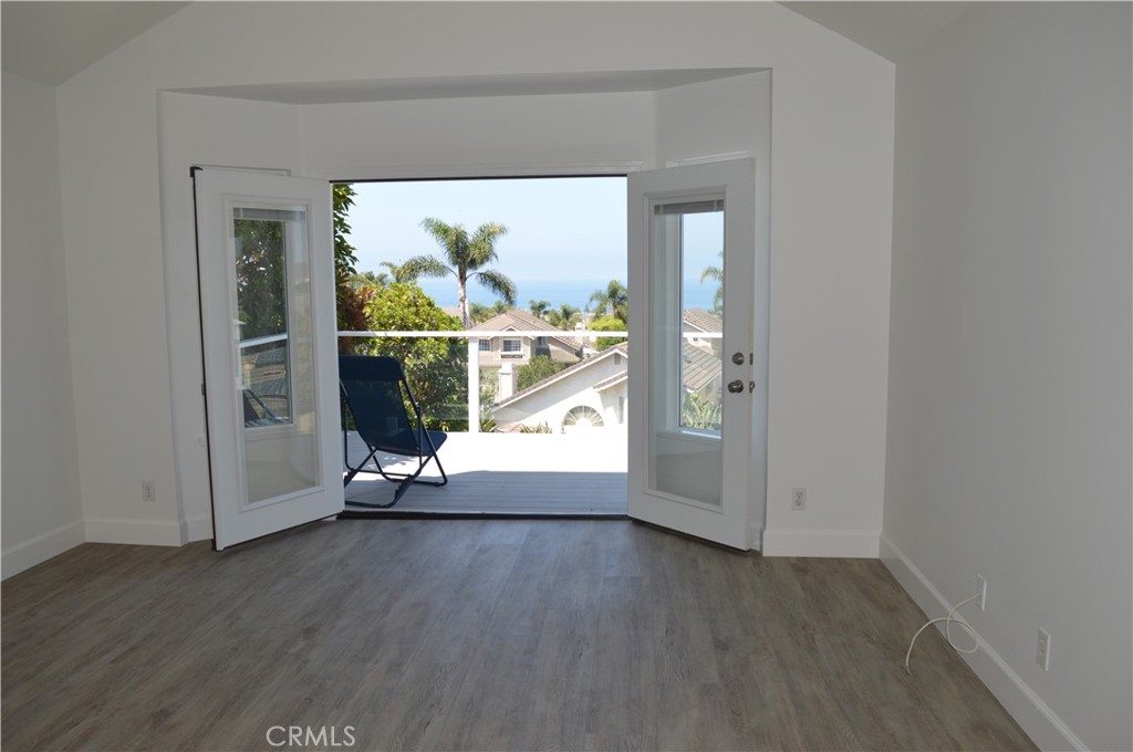 2139 Via Aguila San Clemente, CA 92673 - Photo 12 of 31 an empty room with wooden floor and entrance