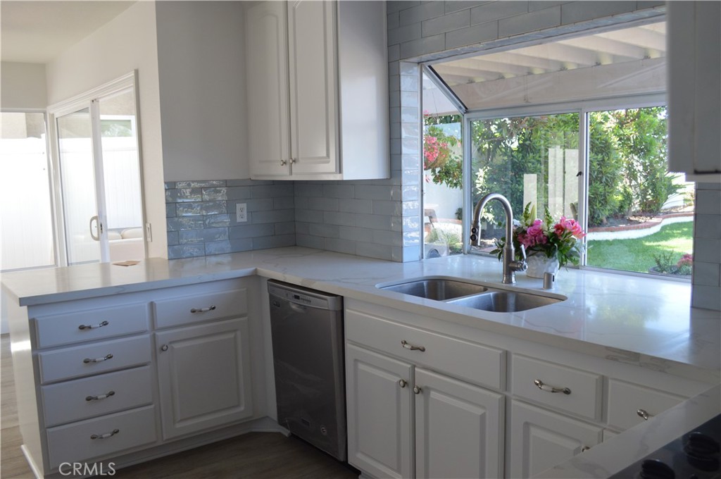2139 Via Aguila San Clemente, CA 92673 - Photo 6 of 31 a kitchen with appliances cabinets and a large window