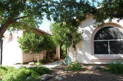 3390 West Desert Bend Loop Tucson, AZ 85742 - Photo 2 of 4 a view of a house with a tree in the yard