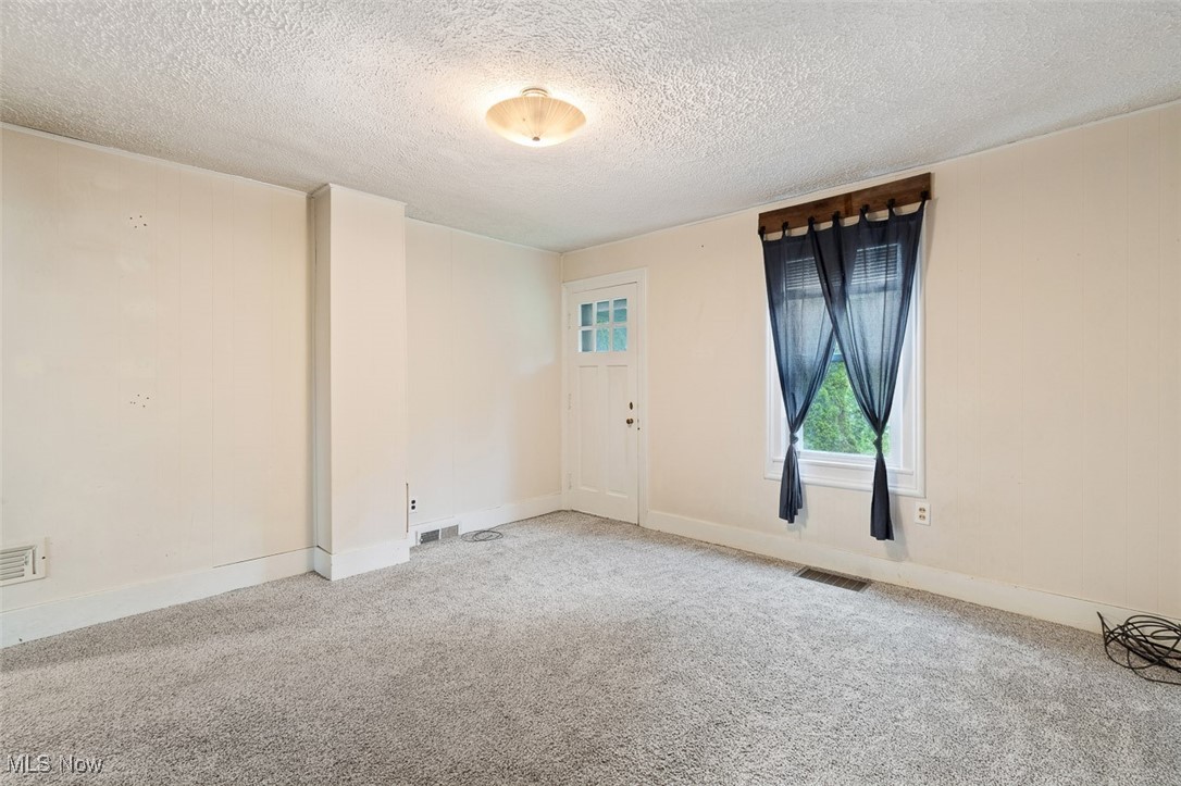 1853 Sylvan Road Wooster, OH 44691 - Photo 8 of 37 Carpeted living room with a textured ceiling and baseboards