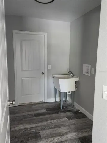 a view of a room with a sink and a mirror