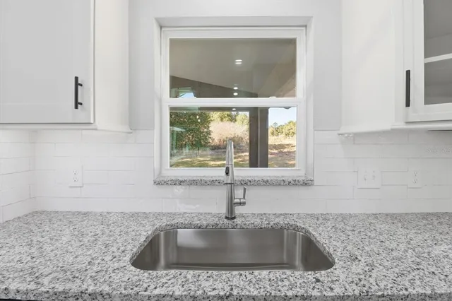 a kitchen with a sink and cabinets