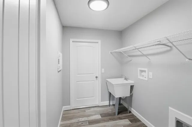 an empty room with a window and ceiling fan