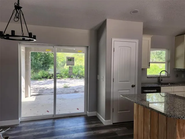 a view of a room with wooden floor and windows