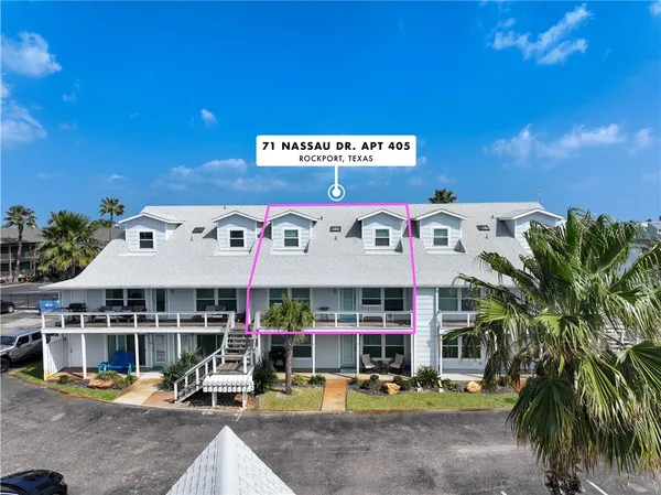 a view of a cafe with a table and chairs under an umbrella