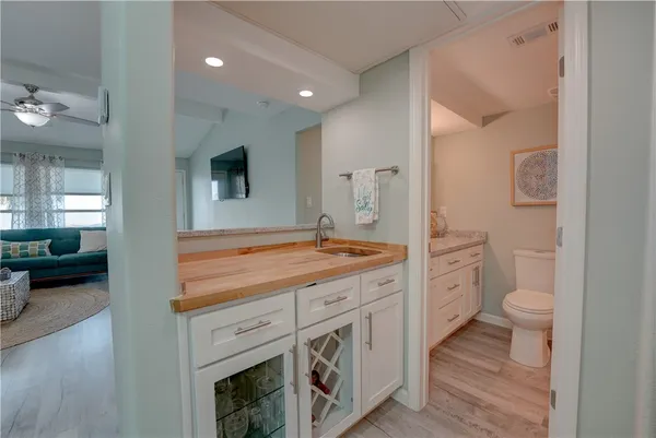 a spacious bathroom with a toilet a sink and a mirror