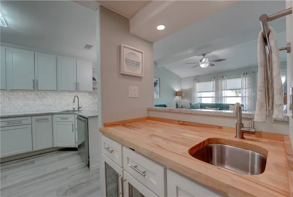 a kitchen with a sink cabinets and wooden floor