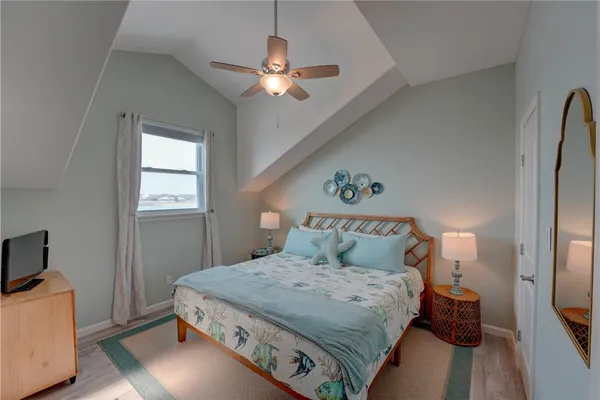 a bedroom with a large bed and a chandelier