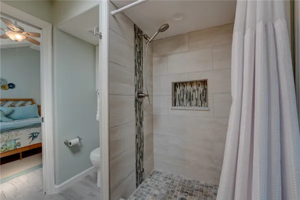 a bathroom with a shower and a sink