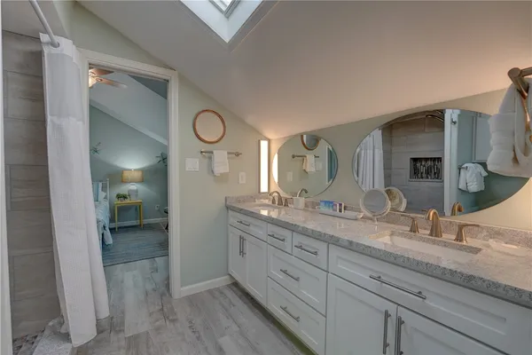 a spacious bathroom with a granite countertop sink and a mirror