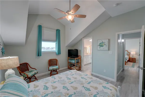 a bedroom with furniture and a flat screen tv