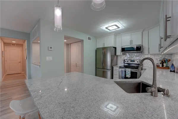 a kitchen with refrigerator and windows