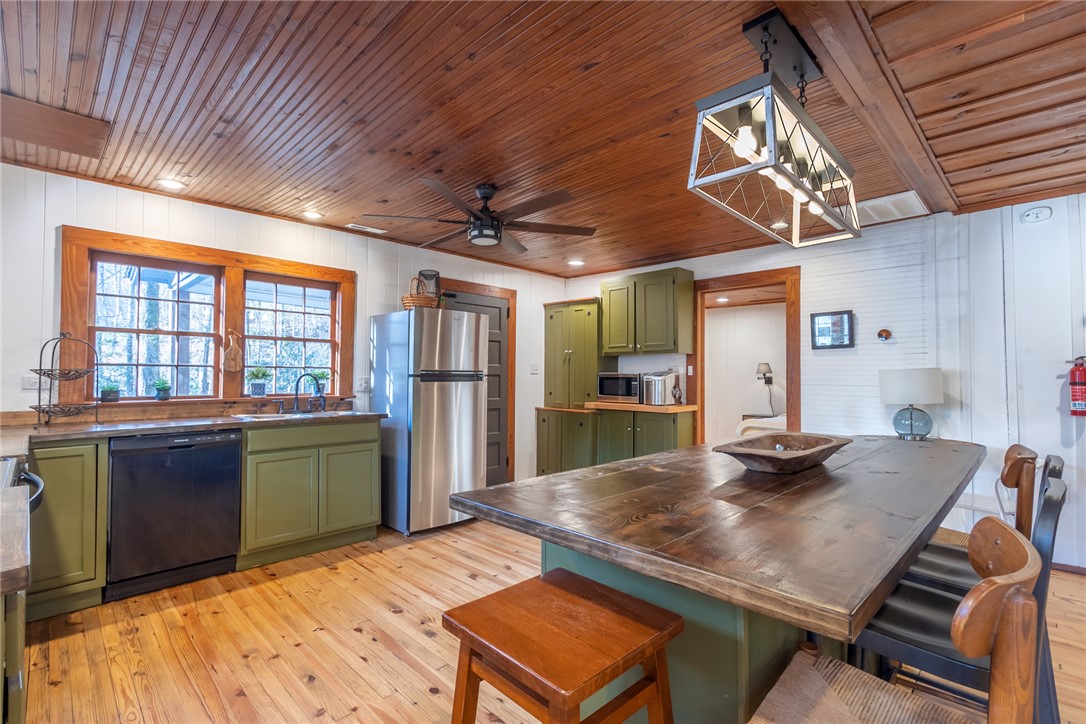 205 Rocky Bottom Road Sunset, SC 29685 - Photo 11 of 46 Warm wood ceilings and matching plank floors create an inviting rustic ambiance in this kitchen.