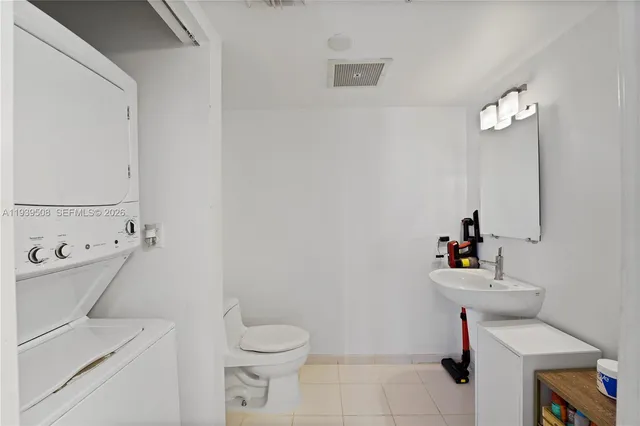a bathroom with a sink toilet and a mirror