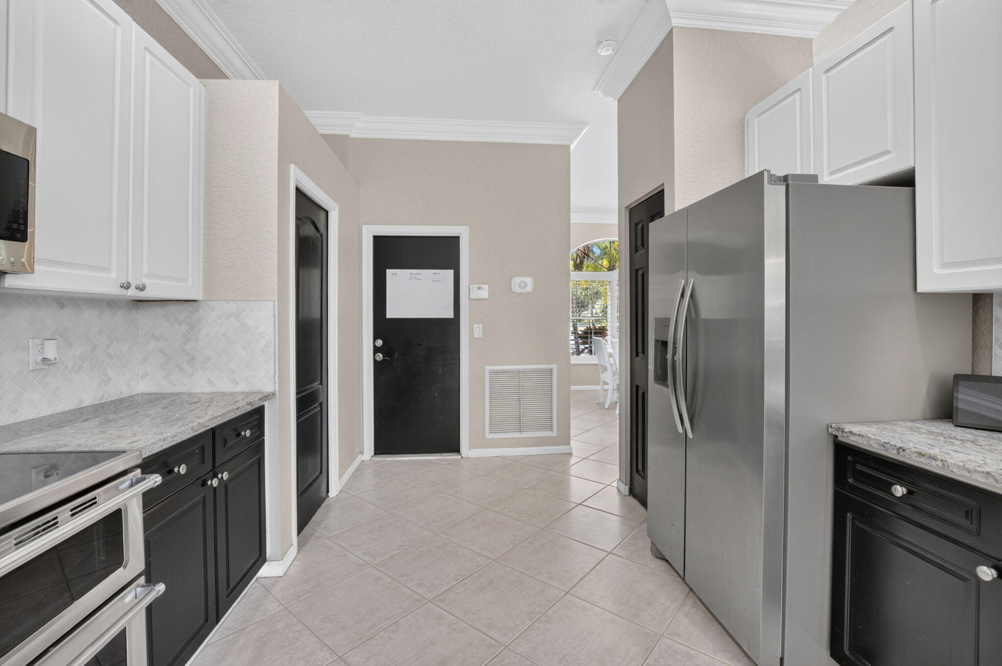 1365 East Barwick Ranch Circle Delray Beach, FL 33445 - Photo 34 of 77 a kitchen with stainless steel appliances granite countertop a refrigerator and a stove
