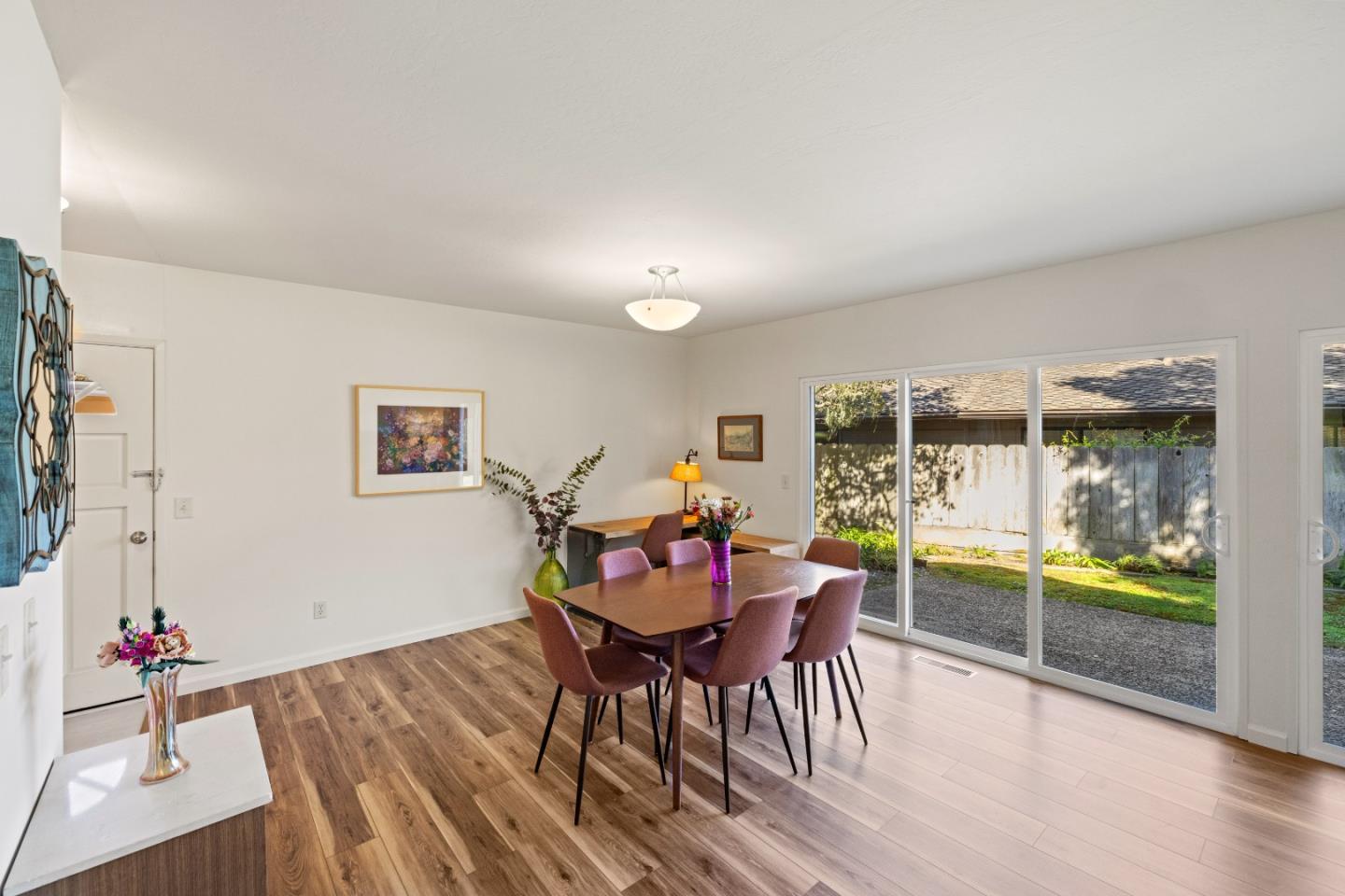 902 Maple Street Pacific Grove, CA 93950 - Photo 11 of 35 a view of a dining room with furniture and wooden floor