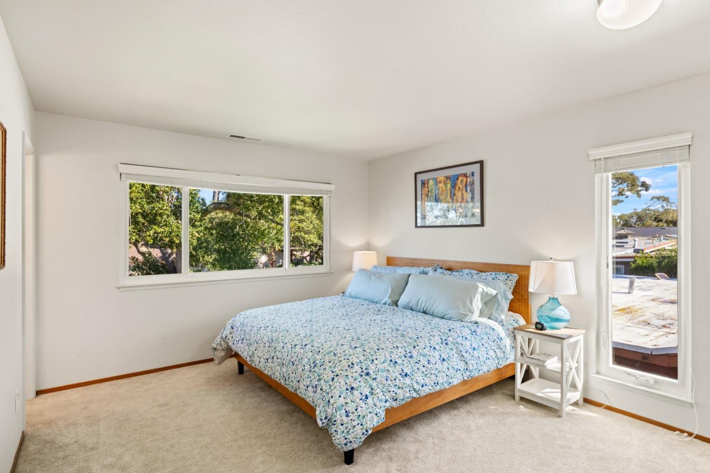 902 Maple Street Pacific Grove, CA 93950 - Photo 15 of 35 a bedroom with a bed and a window