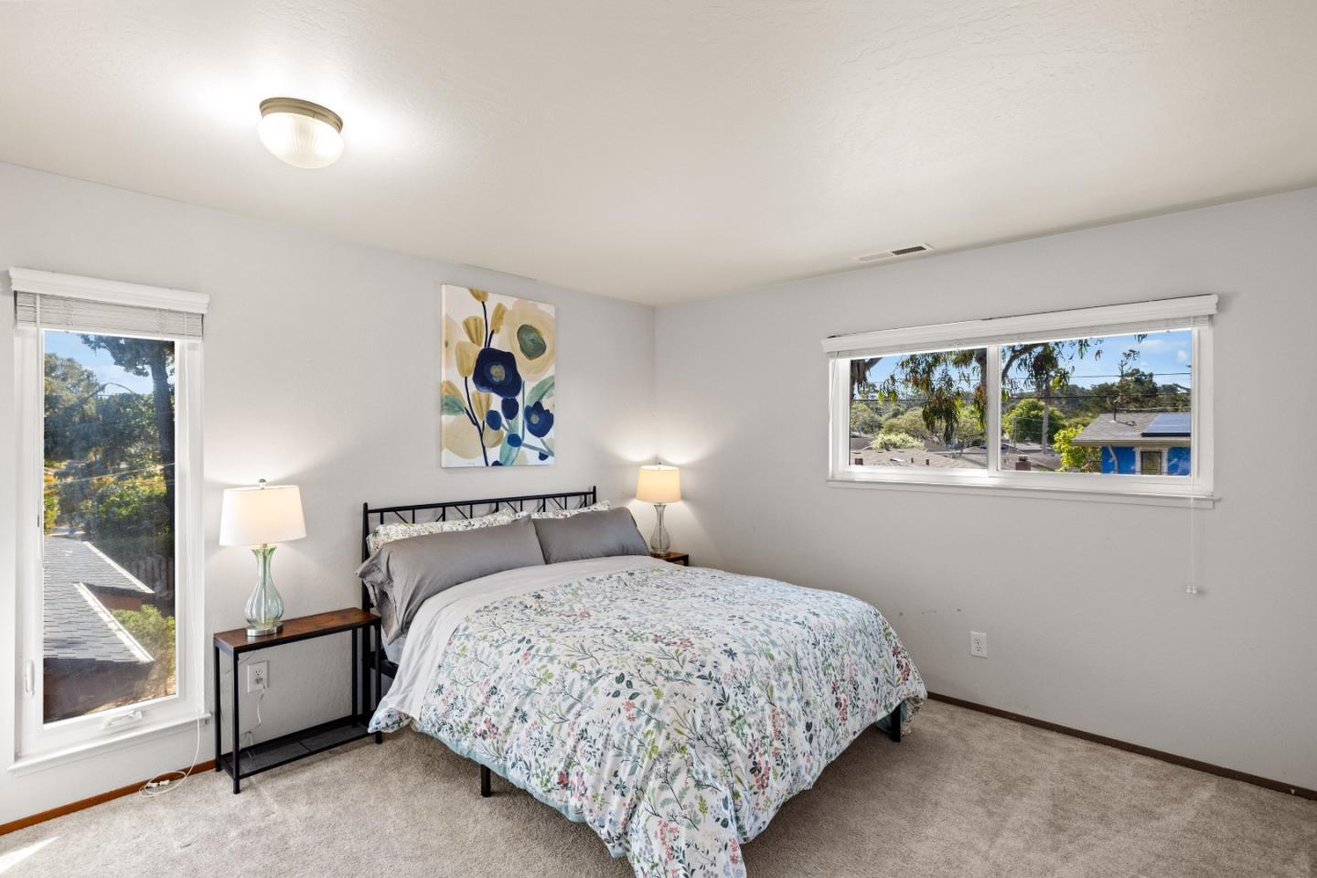 902 Maple Street Pacific Grove, CA 93950 - Photo 20 of 35 a bedroom with a bed and a painting on the wall