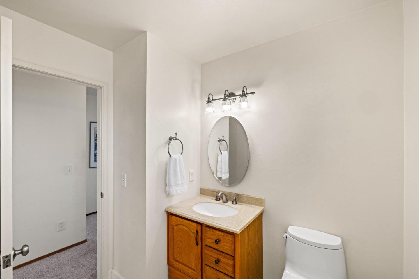 902 Maple Street Pacific Grove, CA 93950 - Photo 22 of 35 a bathroom with a toilet sink and mirror