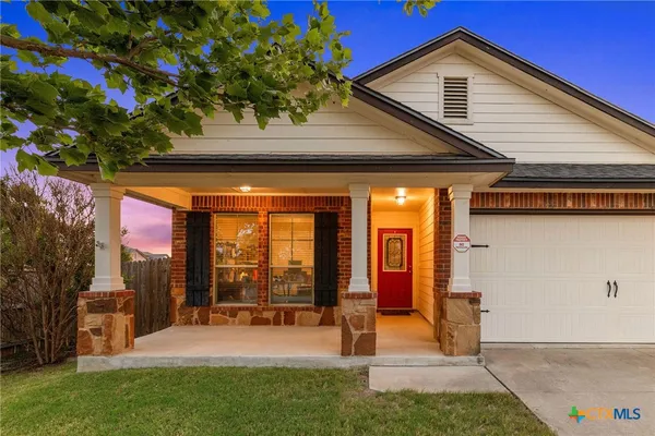 a view of a house with backyard porch and sitting area