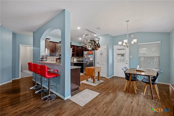 a view of a room with furniture and wooden floor