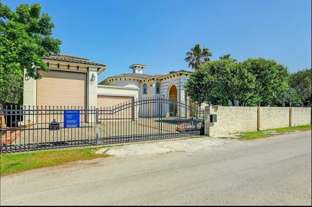 a view of a house with a wooden fence