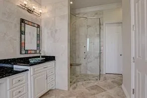 a bathroom with a granite countertop sink a mirror and a shower