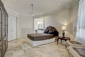 a spacious bedroom with a bed and a cabinets