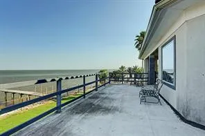 a balcony with chairs and a table