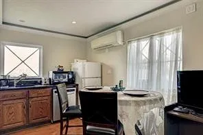 a kitchen with a refrigerator and a stove top open