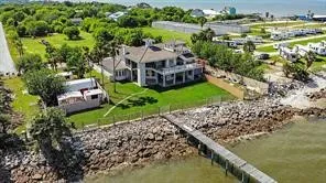 a aerial view of a house with a garden and lake view
