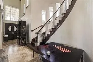 a view of entryway with wooden floor and stairs