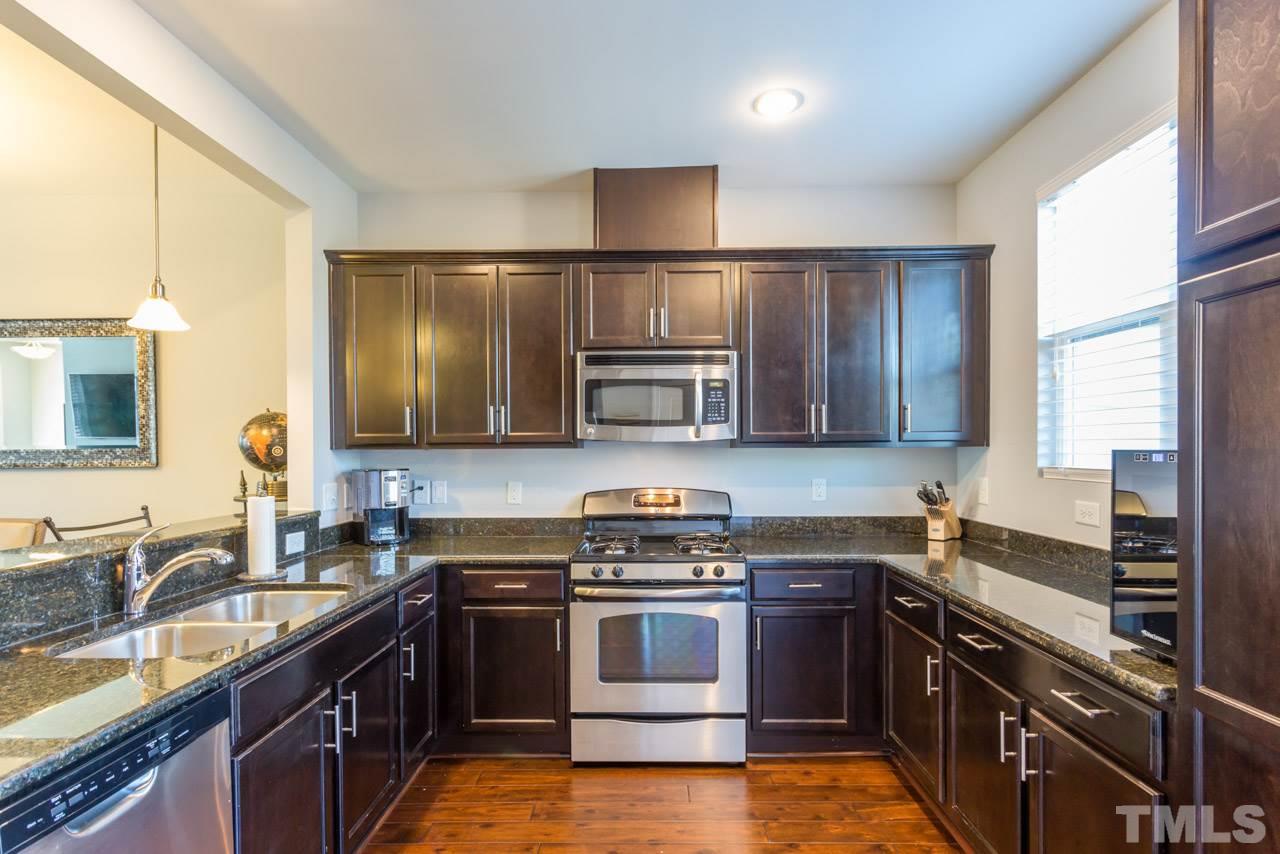 1655 Crafton Way Raleigh, NC 27607 - Photo 11 of 25 a kitchen with stainless steel appliances granite countertop a stove and a sink