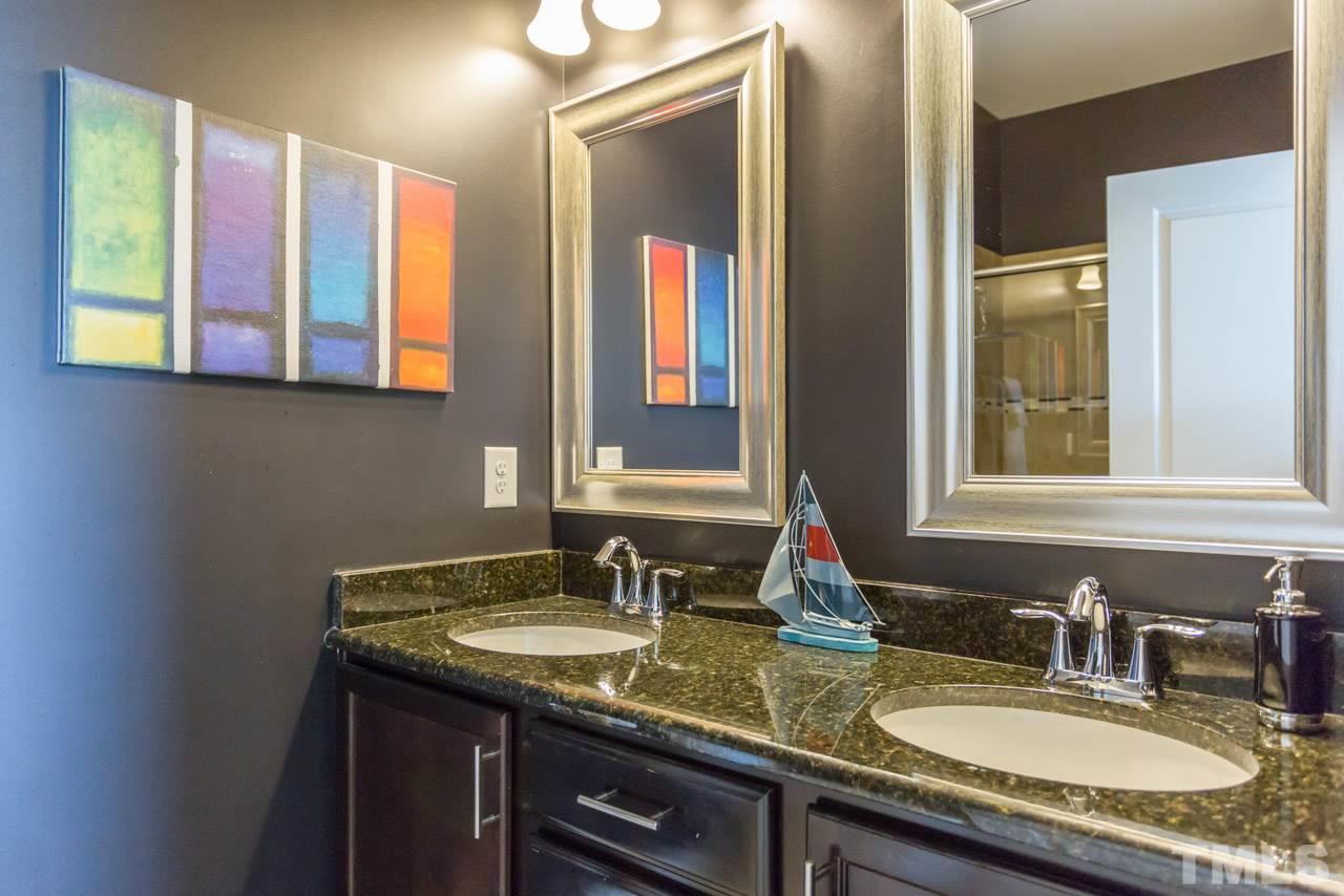 1655 Crafton Way Raleigh, NC 27607 - Photo 16 of 25 a bathroom with a granite countertop double vanity sink and a mirror