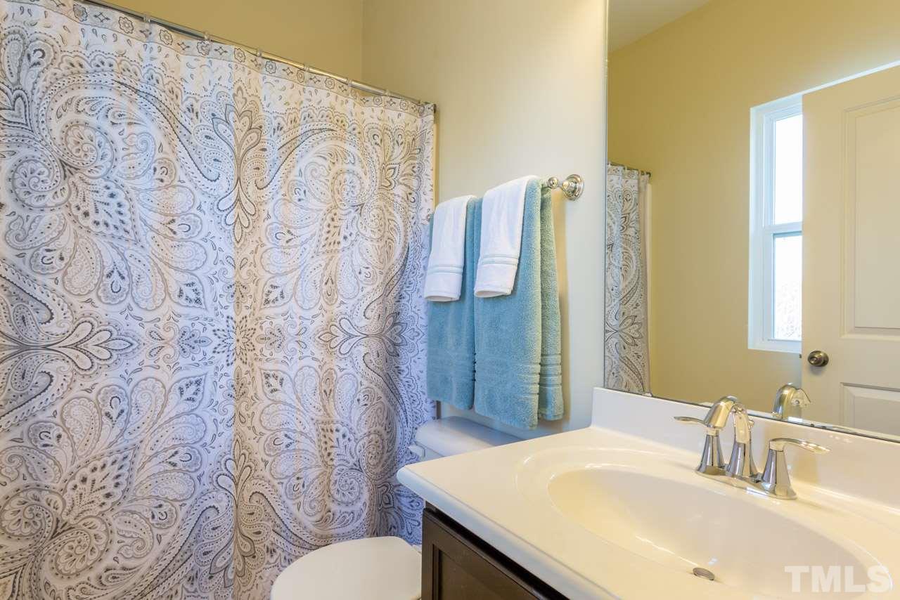 1655 Crafton Way Raleigh, NC 27607 - Photo 19 of 25 a bathroom with a sink and a mirror