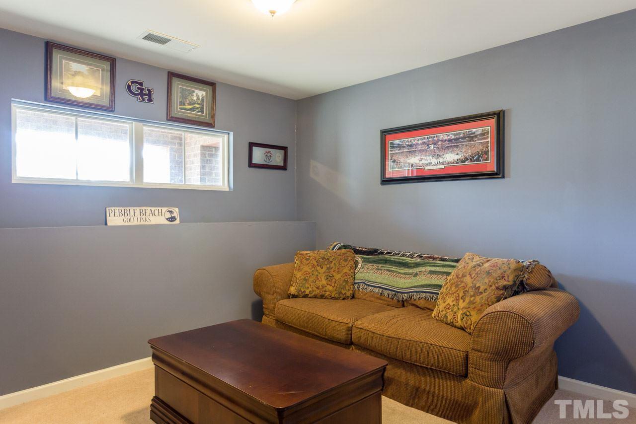 1655 Crafton Way Raleigh, NC 27607 - Photo 22 of 25 a living room with a couch and a window