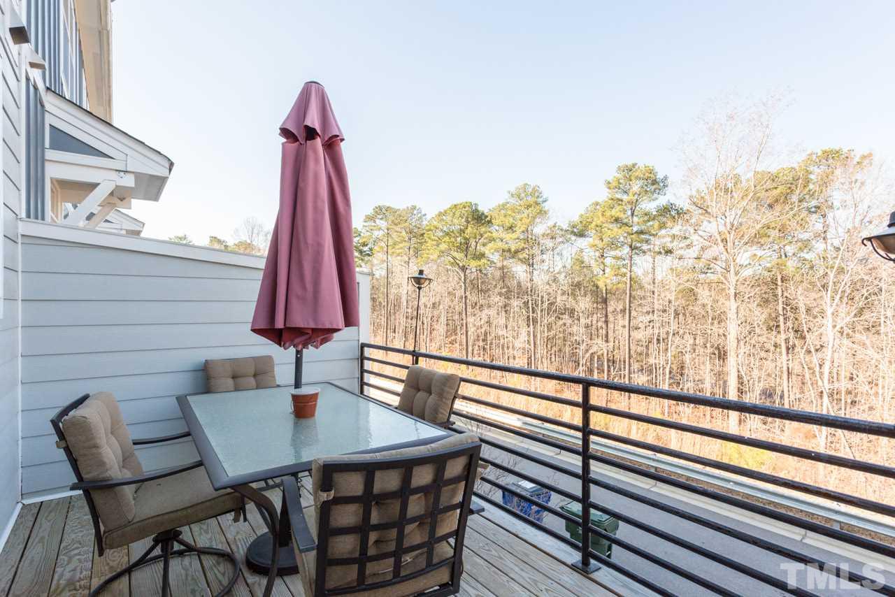 1655 Crafton Way Raleigh, NC 27607 - Photo 25 of 25 a view of a balcony with a table and chairs a barbeque with wooden floor and fence