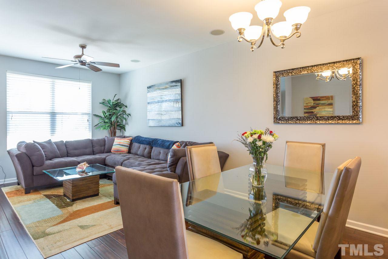 1655 Crafton Way Raleigh, NC 27607 - Photo 7 of 25 a living room with furniture a chandelier and a window