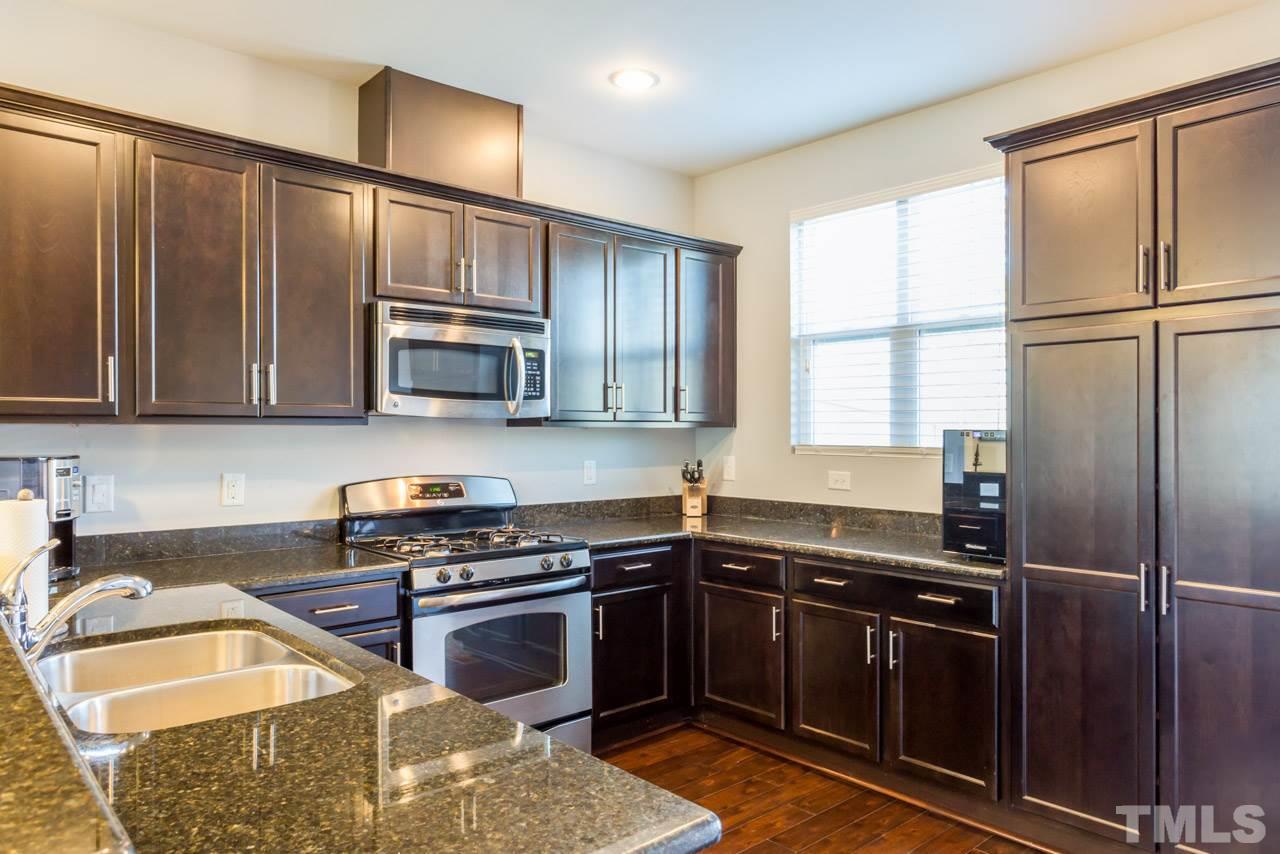 1655 Crafton Way Raleigh, NC 27607 - Photo 8 of 25 a kitchen with granite countertop a sink stainless steel appliances and cabinets