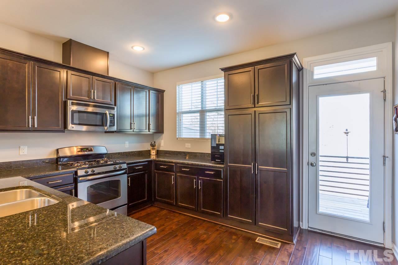 1655 Crafton Way Raleigh, NC 27607 - Photo 9 of 25 a kitchen with granite countertop stainless steel appliances cabinets a sink and a counter space