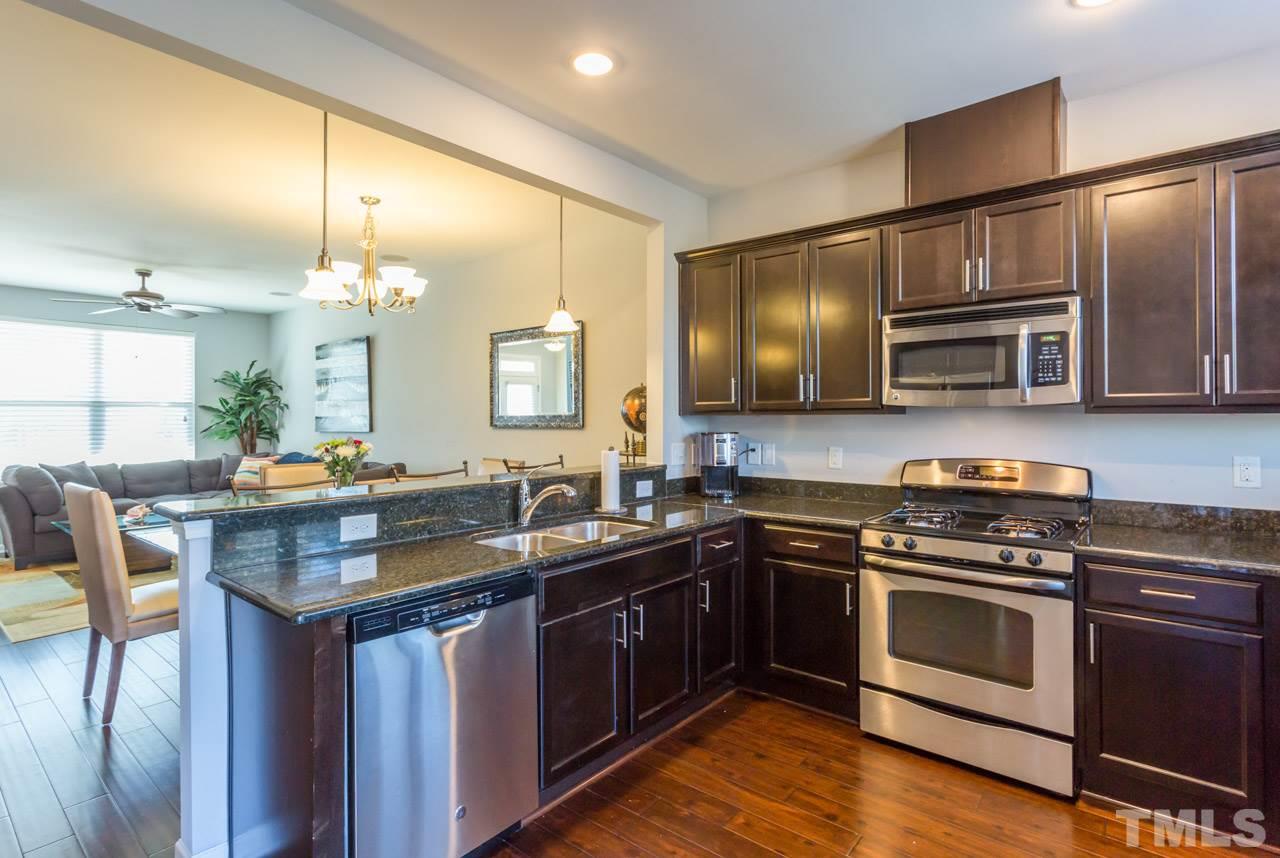 1655 Crafton Way Raleigh, NC 27607 - Photo 10 of 25 a kitchen with stainless steel appliances granite countertop a stove a sink and a microwave