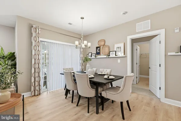 a view of a dining room with furniture and chandelier