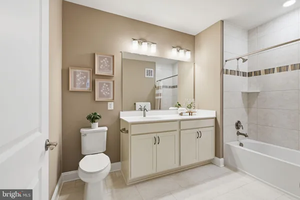 a bathroom with a sink toilet mirror and bathtub