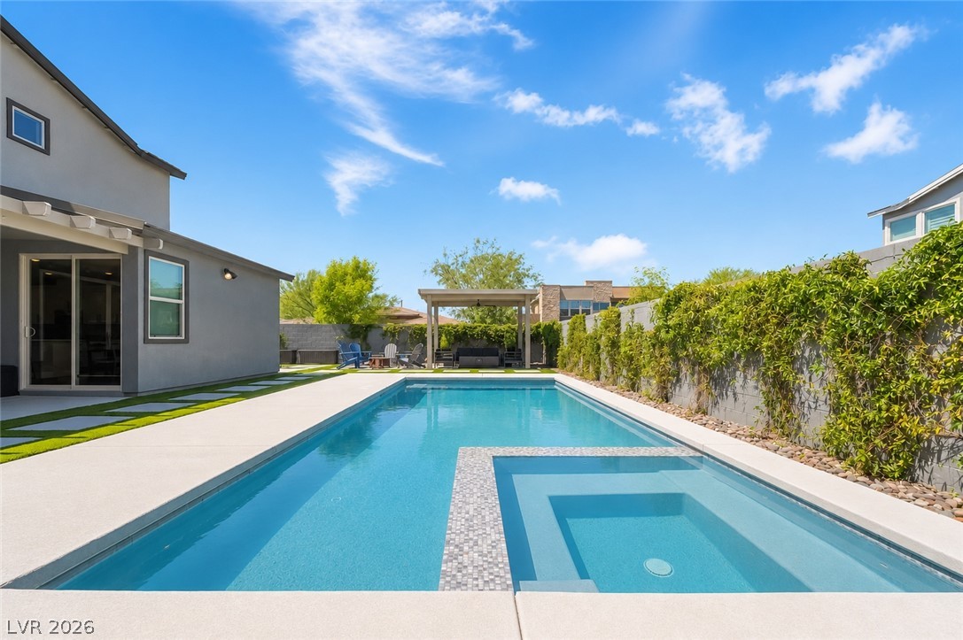 2166 Trivero Street Henderson, NV 89044 - Photo 41 of 61 An inviting backyard oasis offers a sparkling pool and spa, perfect for relaxation and entertainment.