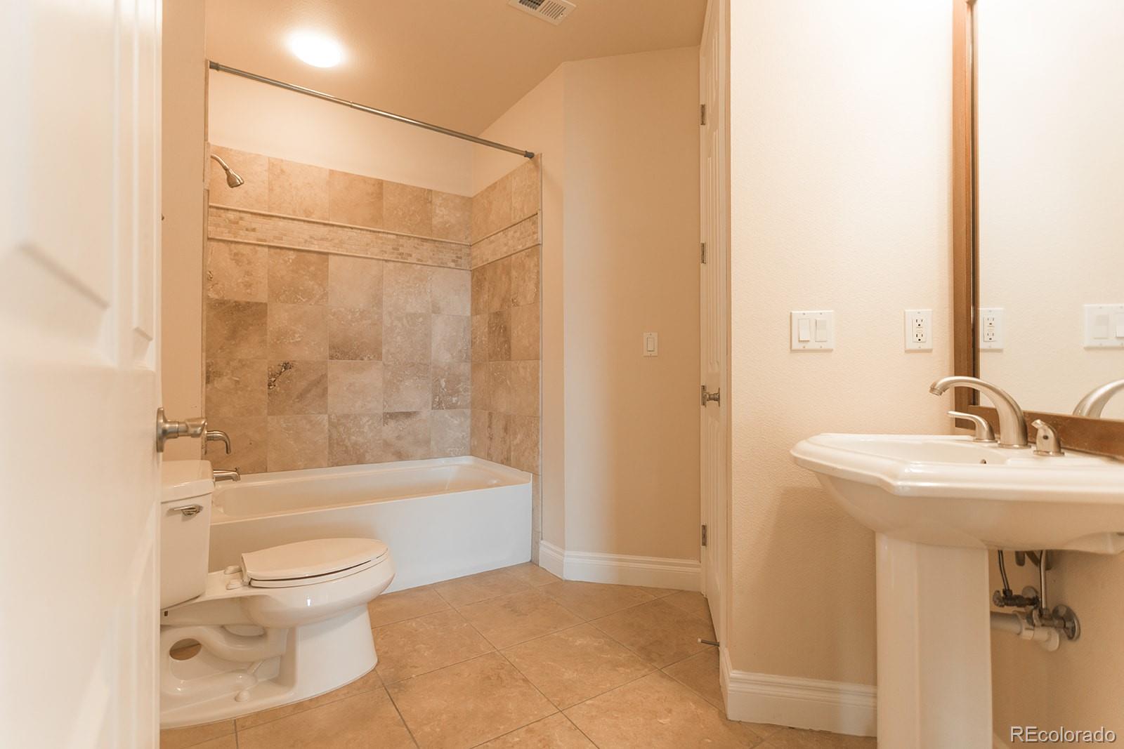 1120 Delaware Street, Unit 201 Denver, CO 80204 - Photo 16 of 25 a bathroom with a sink toilet and shower