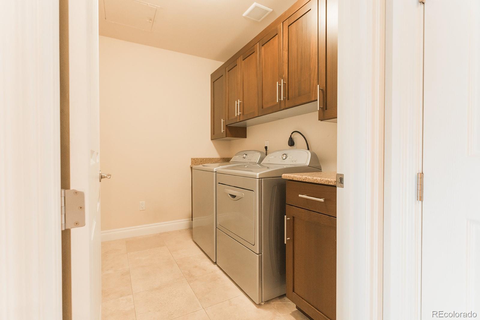 1120 Delaware Street, Unit 201 Denver, CO 80204 - Photo 17 of 25 a view of storage and utility room with washer and dryer
